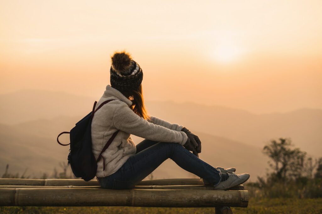 Young woman traveler looking at sunrise